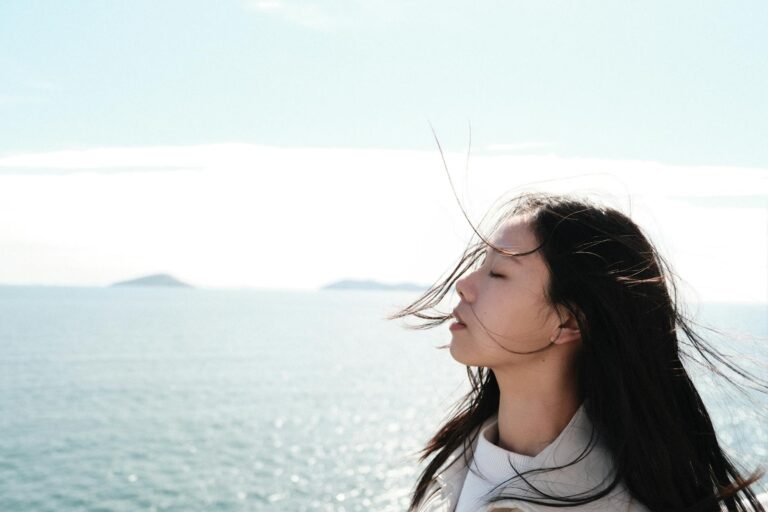 woman enjoying sea breeze